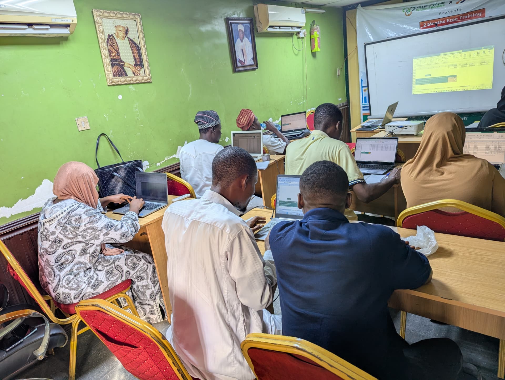 Learners working on Excel exercises during a classroom training session